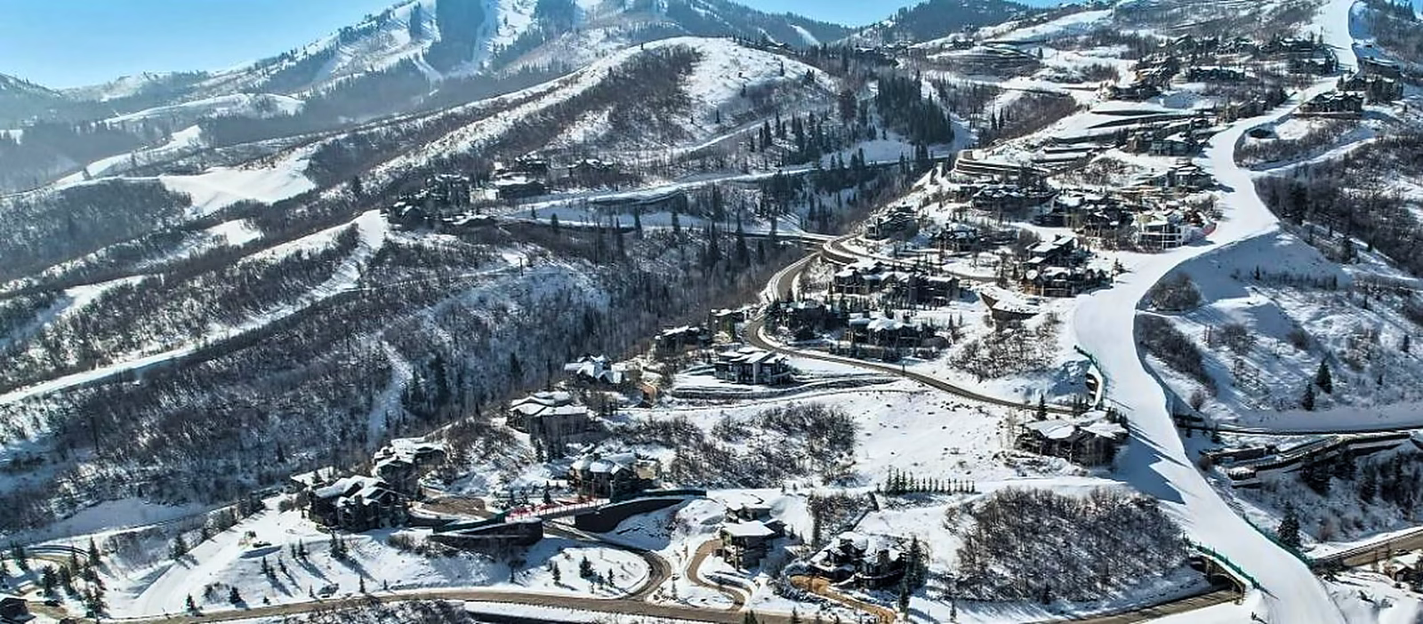 Winter aerial of Deer Crest homes and snow-covered fairways